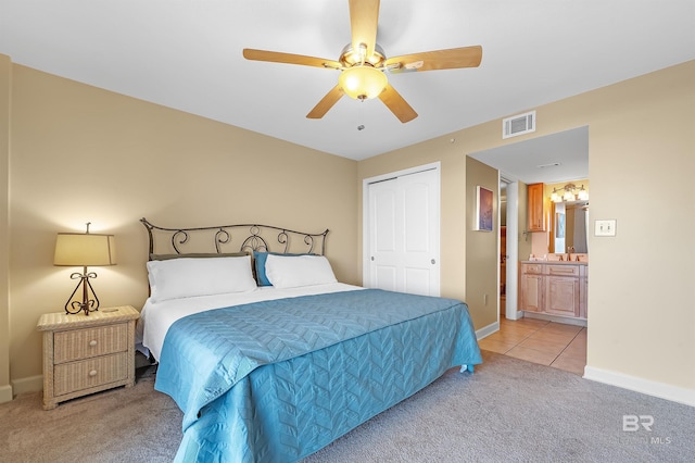 bedroom with baseboards, visible vents, light colored carpet, ceiling fan, and light tile patterned flooring