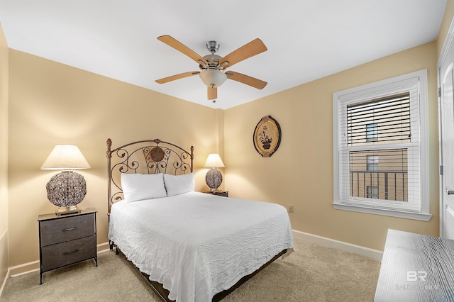 bedroom featuring a ceiling fan, light colored carpet, and baseboards