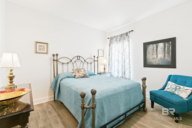 bedroom with wood-type flooring