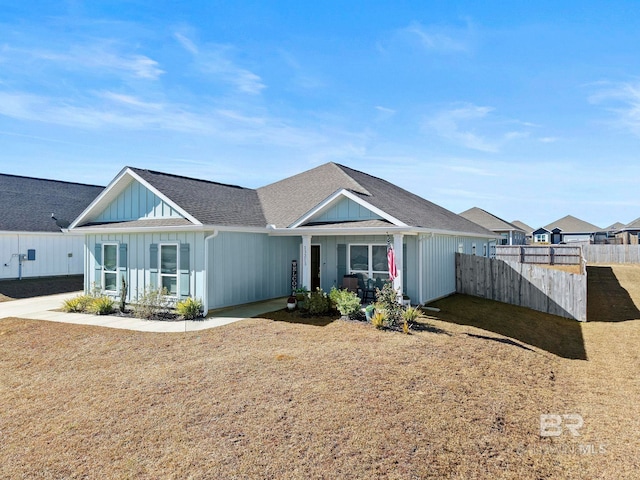 view of front of home with covered porch and a front yard