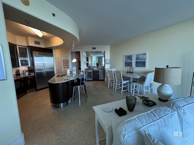 living room featuring wine cooler and sink