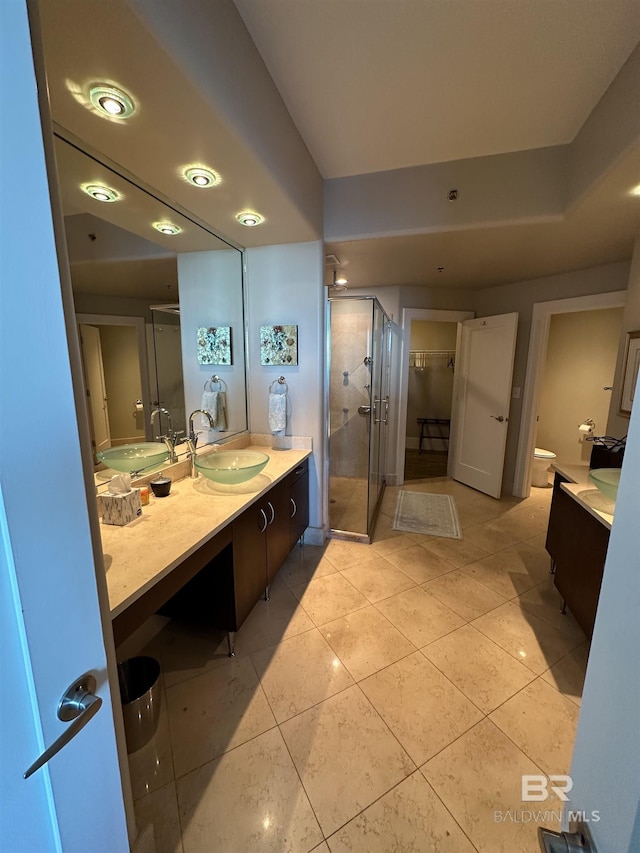 bathroom featuring vanity, an enclosed shower, and tile patterned flooring