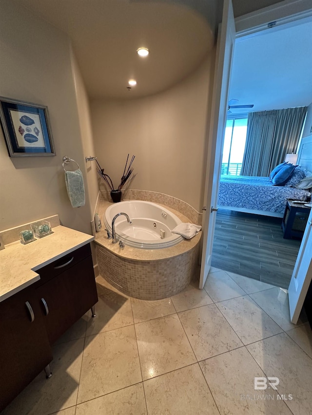 bathroom featuring vanity, tiled bath, and tile patterned floors