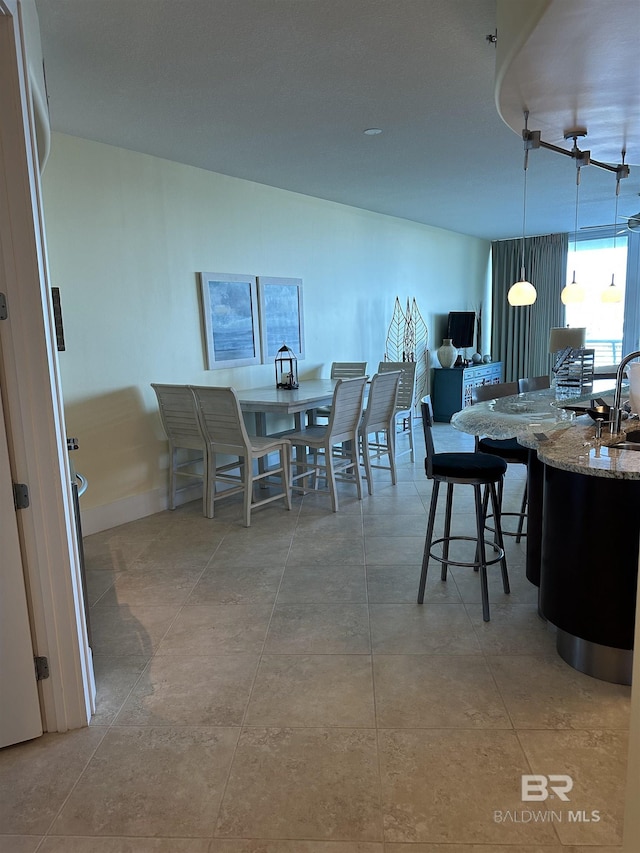 dining space with sink and light tile patterned floors