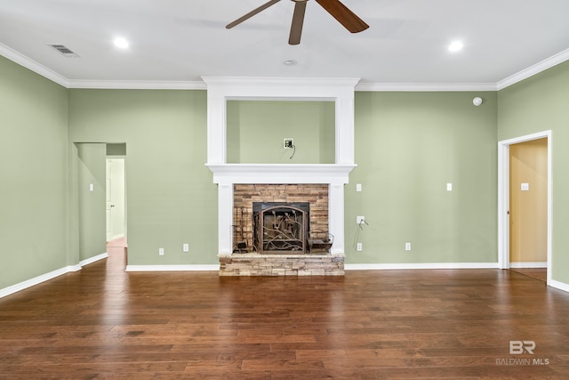 unfurnished living room with dark hardwood / wood-style flooring, a stone fireplace, ceiling fan, and ornamental molding