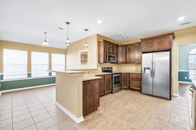 kitchen with pendant lighting, light tile patterned floors, appliances with stainless steel finishes, light stone counters, and kitchen peninsula