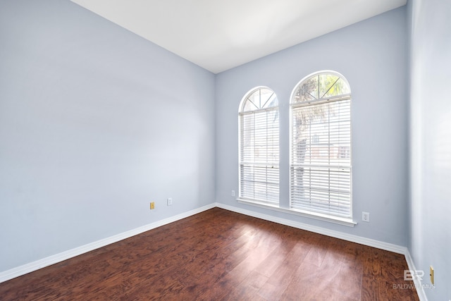 spare room with dark hardwood / wood-style flooring