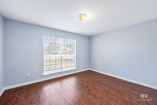 empty room featuring dark wood-type flooring