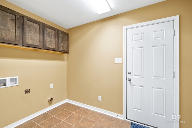 laundry room with electric dryer hookup, cabinets, light tile patterned floors, and washer hookup