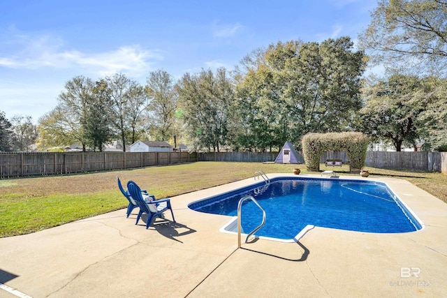 view of swimming pool with a yard and a patio