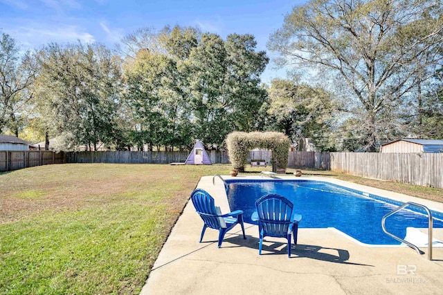 view of pool with a diving board, a patio area, and a lawn