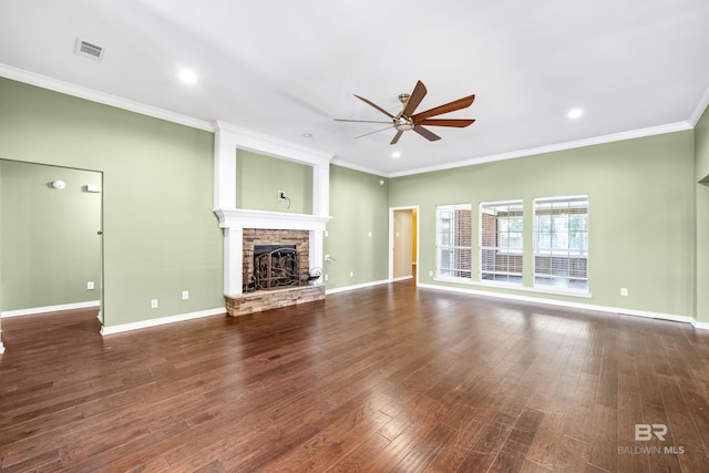 unfurnished living room with ceiling fan, dark hardwood / wood-style flooring, ornamental molding, and a fireplace