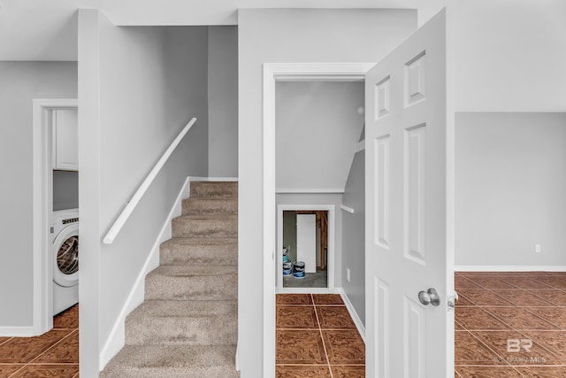 staircase featuring tile patterned flooring and washer / clothes dryer