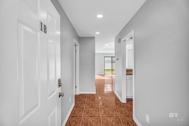 corridor featuring dark tile patterned floors