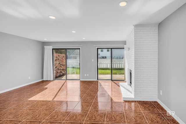 spare room featuring tile patterned floors and a fireplace