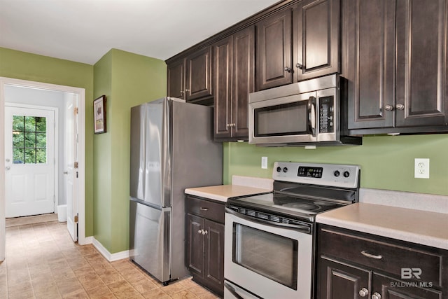 kitchen featuring appliances with stainless steel finishes and dark brown cabinets