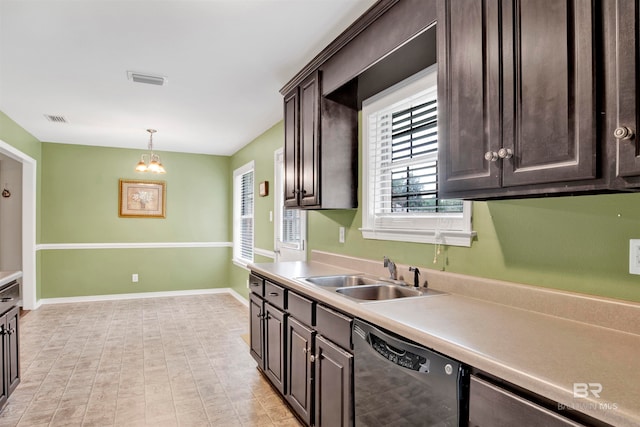 kitchen with pendant lighting, dishwasher, an inviting chandelier, sink, and dark brown cabinetry