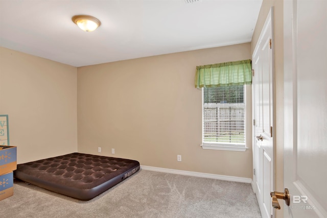 unfurnished bedroom featuring light carpet