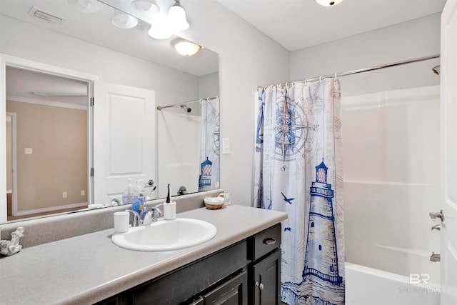 bathroom with crown molding, vanity, and shower / bath combo