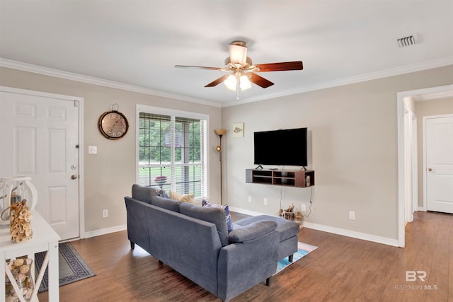 living room with dark wood-type flooring, ceiling fan, and crown molding