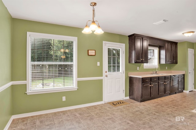 kitchen featuring an inviting chandelier, sink, dark brown cabinets, pendant lighting, and stainless steel dishwasher