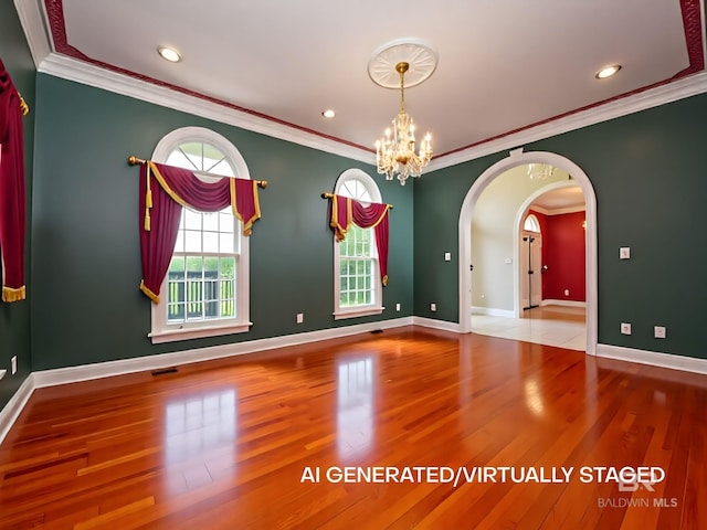 24235 County Road 87, Robertsdale, AL 36567 - spare room with crown molding, wood finished floors, a chandelier, baseboards, and arched walkways