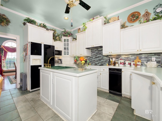 24235 County Road 87, Robertsdale, AL 36567 - kitchen with black appliances, a center island, decorative backsplash, ceiling fan, and white cabinets