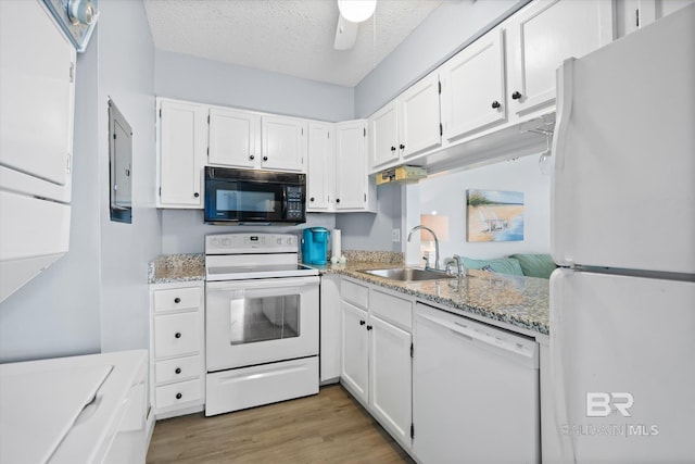 kitchen featuring white appliances, white cabinets, sink, a textured ceiling, and light hardwood / wood-style floors