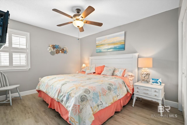 bedroom with ceiling fan and light hardwood / wood-style flooring