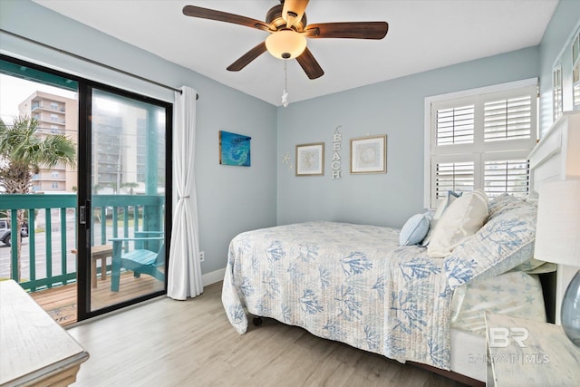 bedroom with access to exterior, wood-type flooring, and ceiling fan