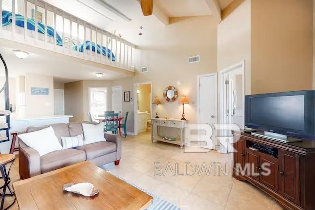 tiled living room featuring a high ceiling and ceiling fan