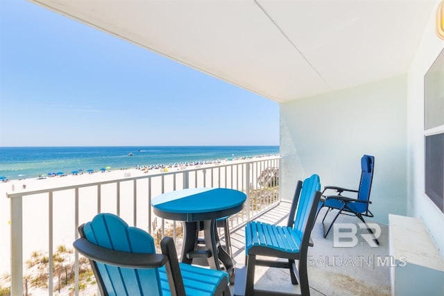 balcony with a beach view and a water view