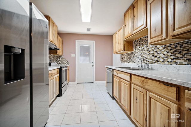 kitchen featuring sink, stainless steel appliances, light tile patterned floors, and decorative backsplash