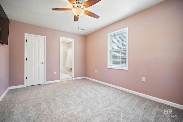 unfurnished bedroom with ceiling fan, connected bathroom, and carpet flooring