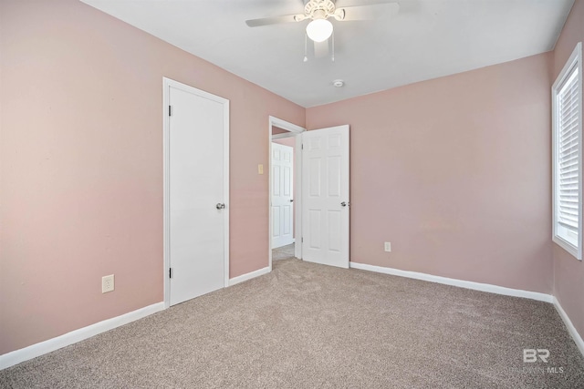 unfurnished bedroom featuring ceiling fan and carpet floors