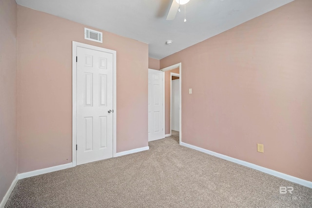 unfurnished bedroom featuring ceiling fan and carpet flooring