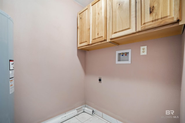 clothes washing area featuring washer hookup, cabinets, electric dryer hookup, and light tile patterned flooring