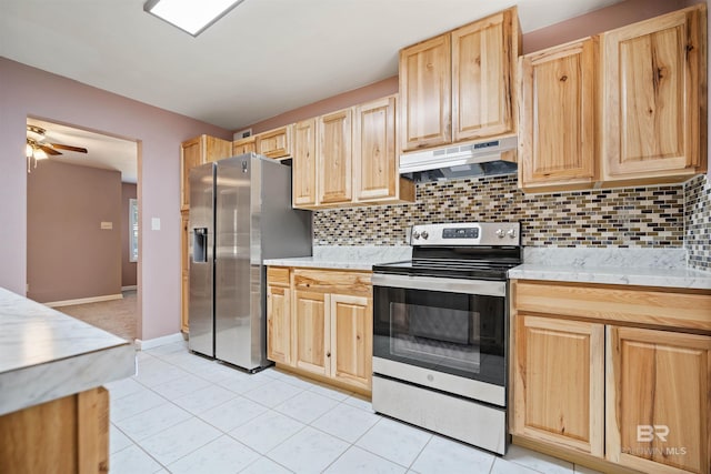 kitchen featuring stainless steel appliances, light tile patterned floors, decorative backsplash, and light brown cabinets