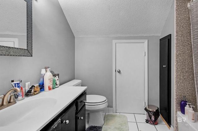 31375 Stagecoach Rd, Spanish Fort, AL 36527 - bathroom featuring a textured ceiling, vanity, tile patterned floors, toilet, and lofted ceiling
