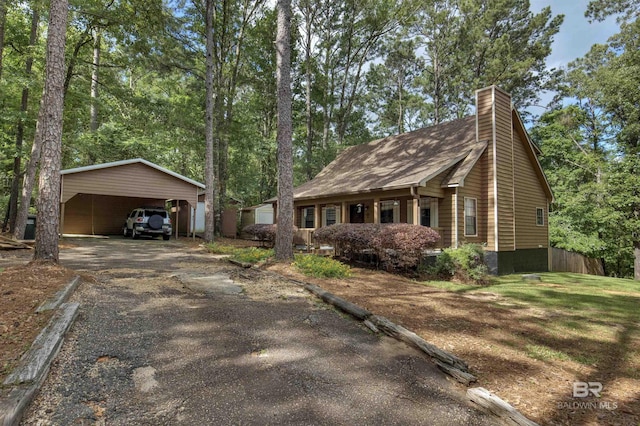 31375 Stagecoach Rd, Spanish Fort, AL 36527 - view of front of home with asphalt driveway, a chimney, and a detached carport