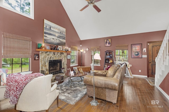 31375 Stagecoach Rd, Spanish Fort, AL 36527 - living area with high vaulted ceiling, ceiling fan, a stone fireplace, hardwood / wood-style flooring, and plenty of natural light