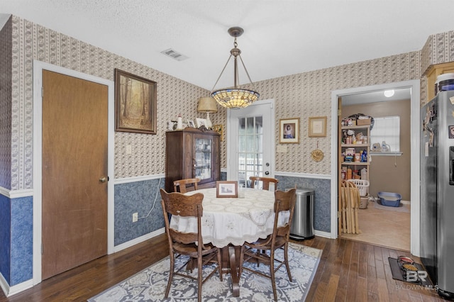 31375 Stagecoach Rd, Spanish Fort, AL 36527 - dining area with wallpapered walls, dark wood-type flooring, baseboards, and a chandelier
