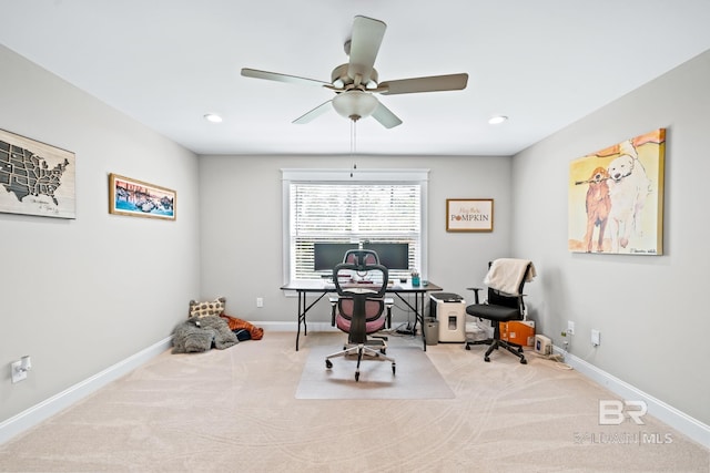 carpeted office space with ceiling fan