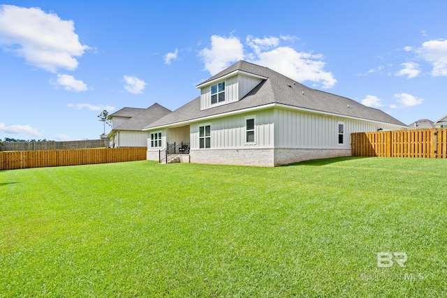 back of property featuring a patio area and a yard