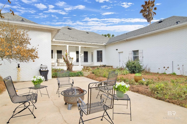 view of patio / terrace featuring an outdoor fire pit