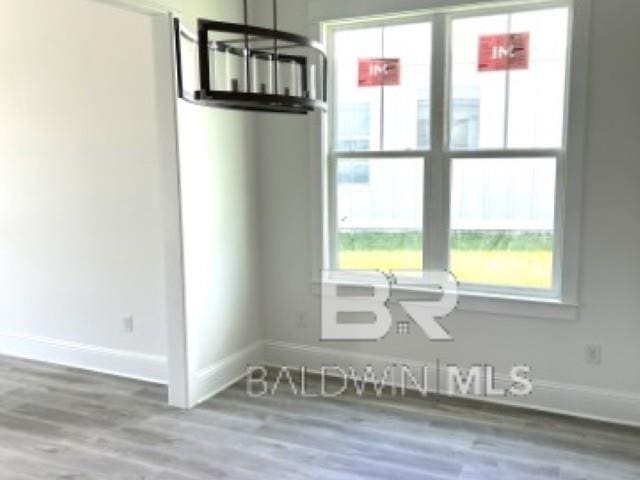 1257 Dorado Way, Gulf Shores, AL 36542 - spare room featuring baseboards and wood finished floors