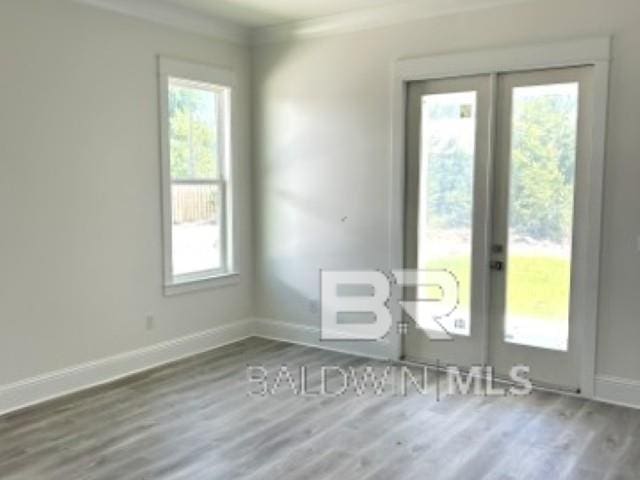 1257 Dorado Way, Gulf Shores, AL 36542 - spare room with french doors, wood finished floors, healthy amount of natural light, baseboards, and crown molding