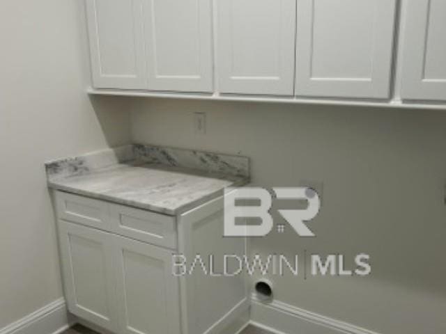 1257 Dorado Way, Gulf Shores, AL 36542 - laundry area featuring cabinet space and baseboards