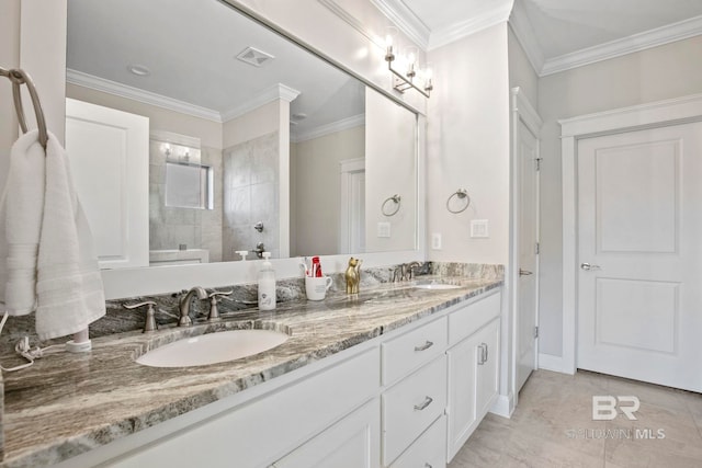 bathroom with a sink, visible vents, and crown molding