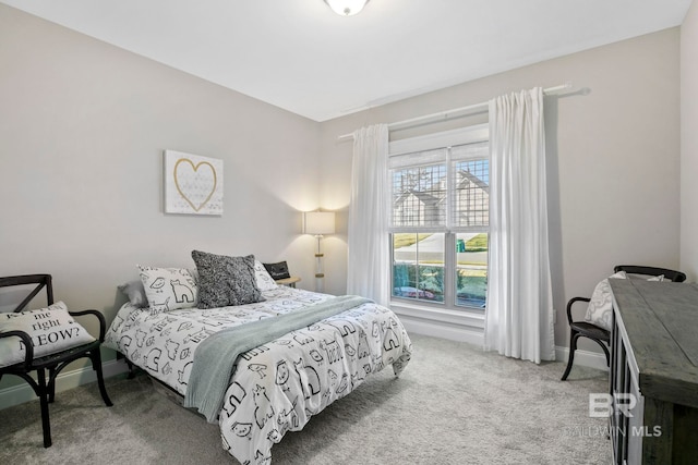 bedroom featuring baseboards and carpet